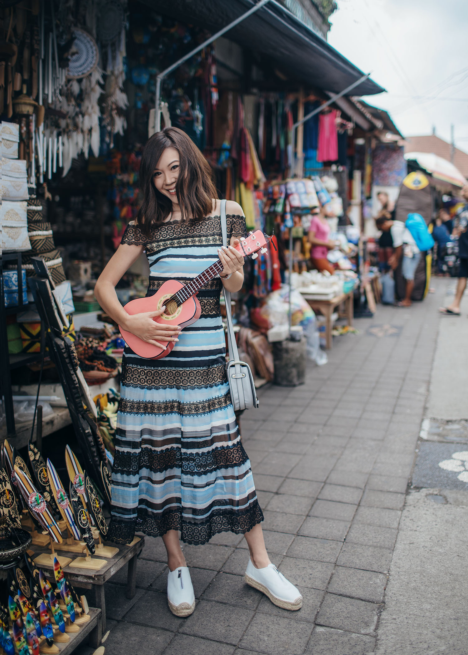 Fashion and travel blogger influencer Jenny Tsang of Tsangtastic traveling in Bali, Indonesia, wearing TADASHI SHOJI Dress, at Ubud Market.