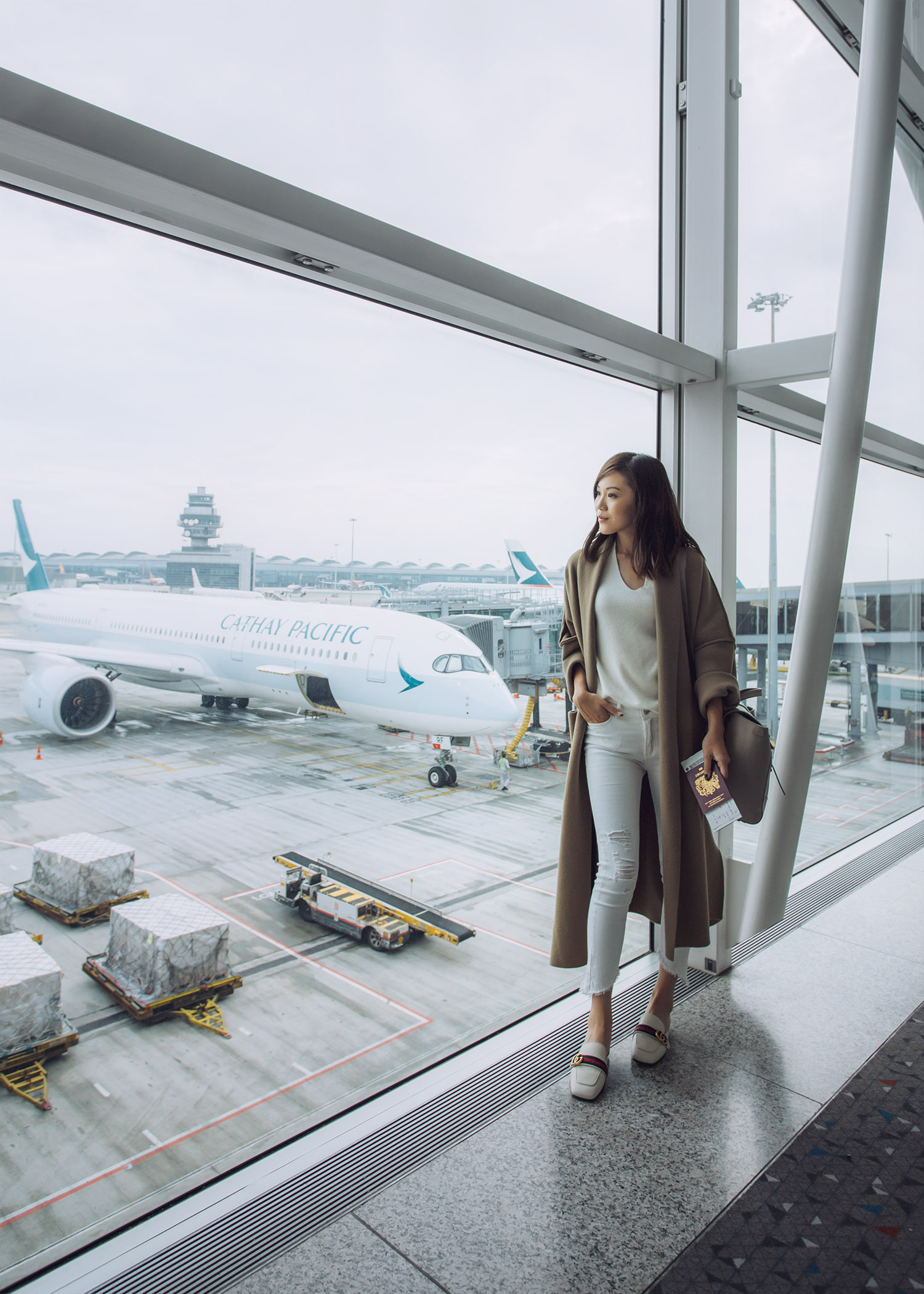 Fashion and travel blogger influencer Jenny Tsang of Tsangtastic traveling in Hong Kong, with Cathay Pacific, wearing Vince Cashmere Sweater and Gucci White Leather Slipper.