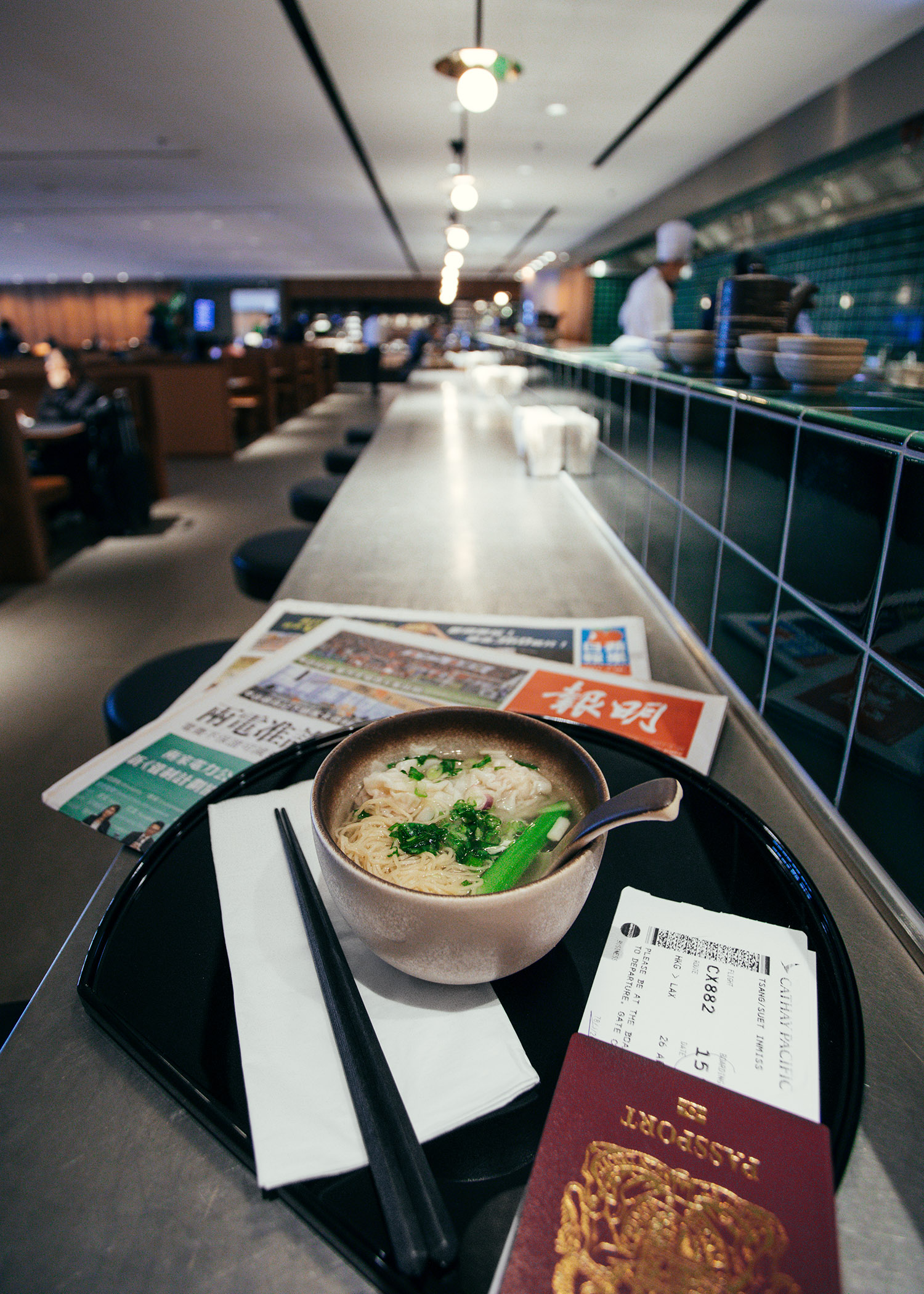 Fashion and travel blogger influencer Jenny Tsang of Tsangtastic traveling in Hong Kong, with Cathay Pacific, in business lounge enjoying the noodle bar.