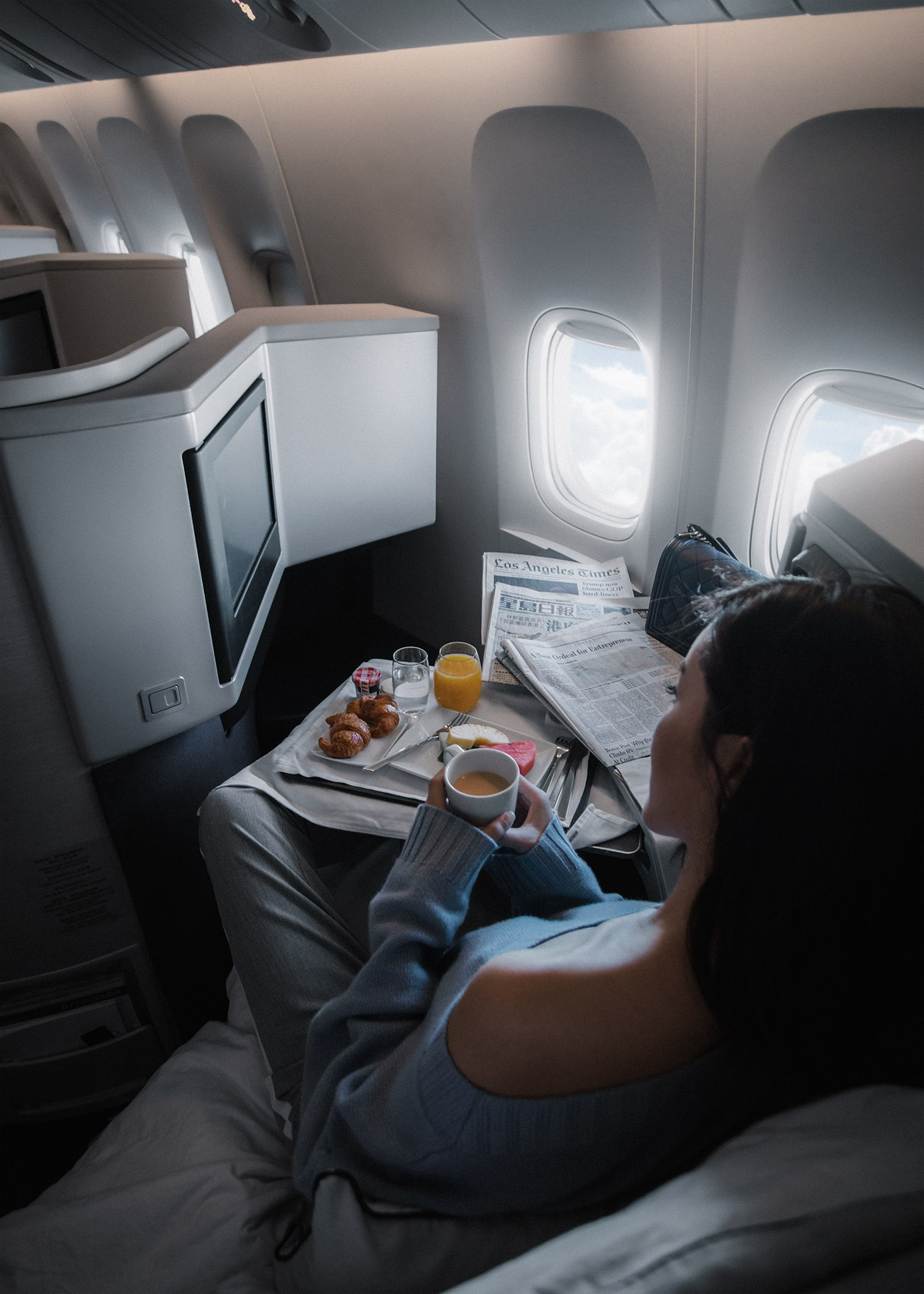 Fashion and travel blogger influencer Jenny Tsang of Tsangtastic traveling in Hong Kong, with Cathay Pacific in business class, wearing Vince Cashmere Off Shoulder Sweater and Gucci White Leather Slipper.