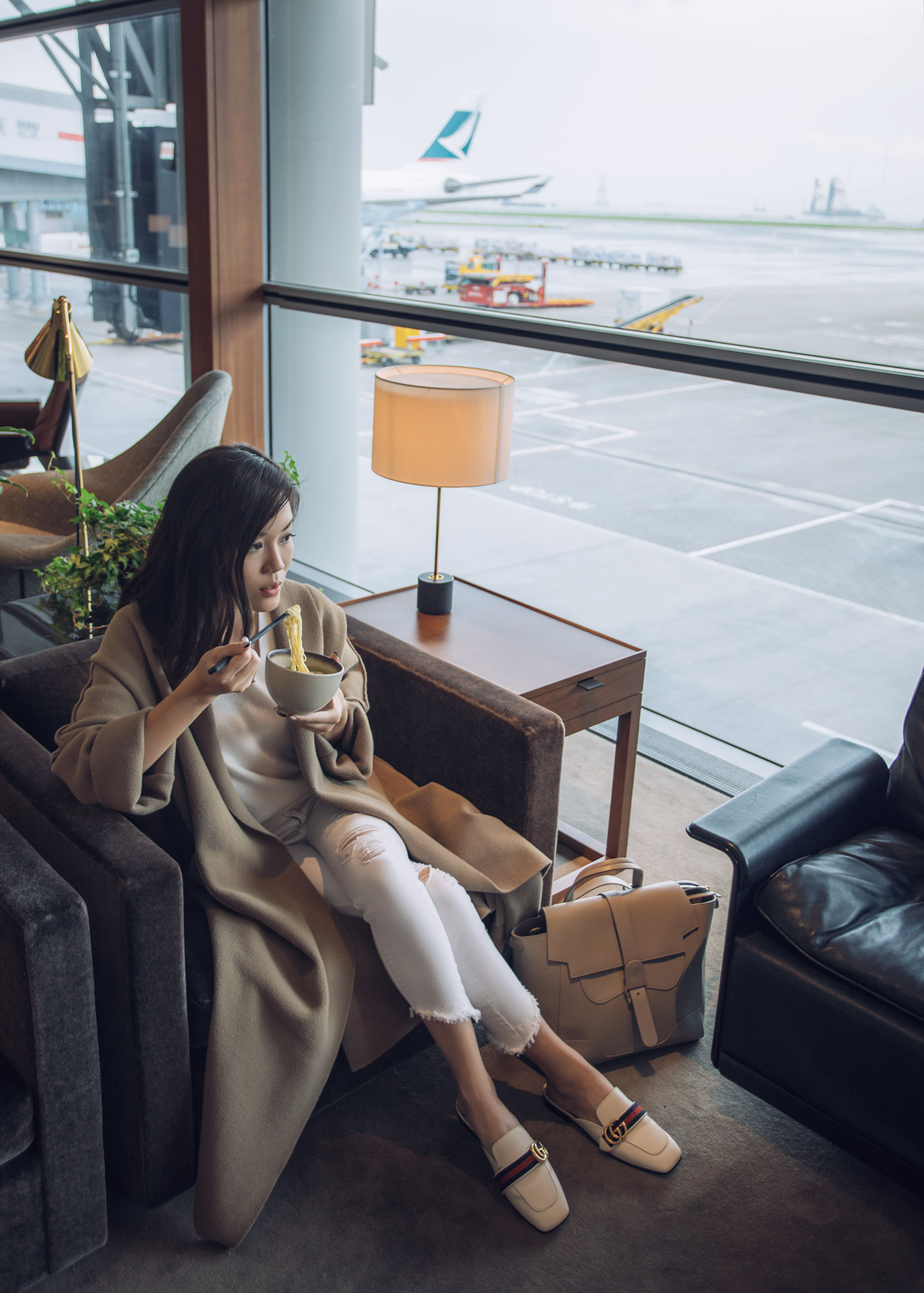 Fashion and travel blogger influencer Jenny Tsang of Tsangtastic traveling in Hong Kong, with Cathay Pacific, wearing Vince Cashmere Sweater and Gucci White Leather Slipper.