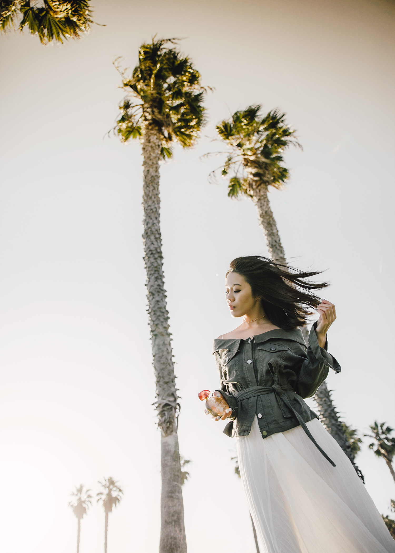 Street style fashion blogger influencer Jenny Tsang of Tsangtastic wearing ROBERT RODRIGUEZ Off Shoulder Jacket, C/MEO COLLECTIVE White Evoke Dress, L'Occitane en Provence Terre de Lumiere and ROGER VIVIER Sneaky Viv, in Los Angeles, Venice, California.