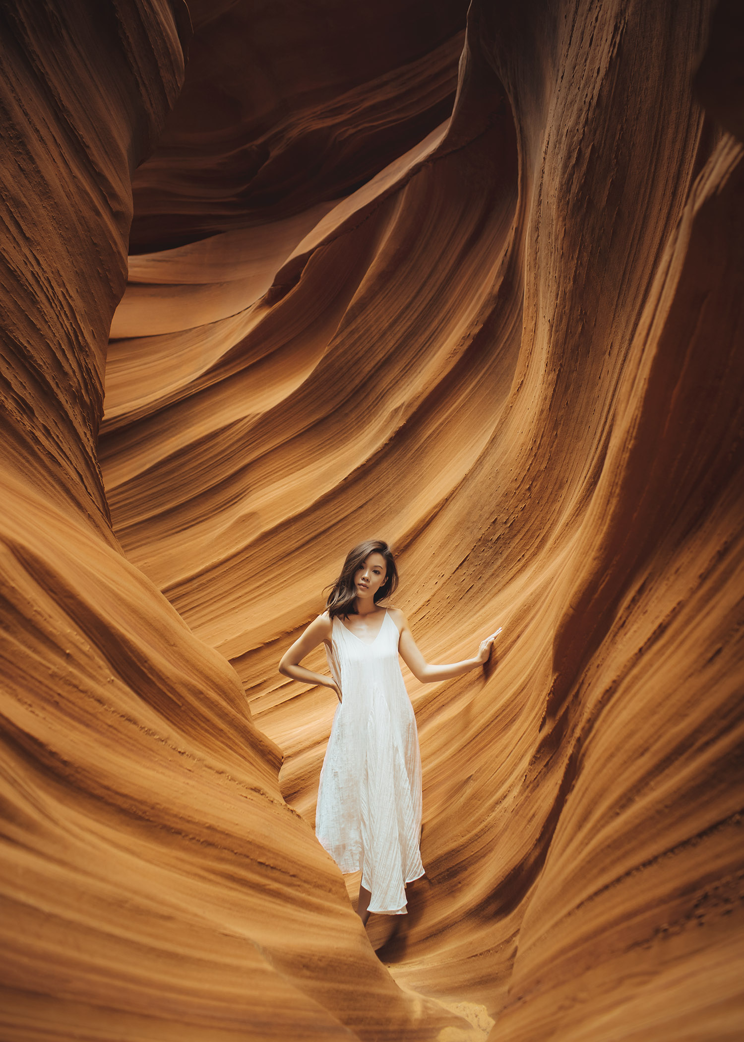 Lifestyle fashion travel blogger Jenny Tsang of Tsangtastic wearing white dress and white sneakers in Antelope Canyon in Arizona