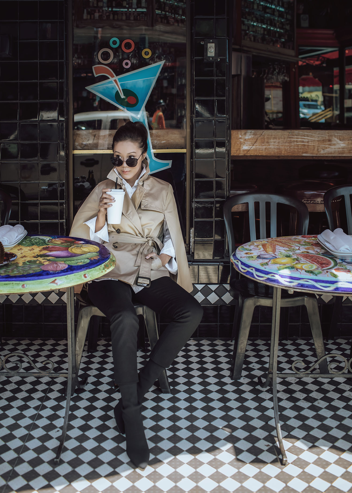 Street style fashion blogger influencer Jenny Tsang of Tsangtastic wearing trench cape white shirt black straight pant sock boots in San Francisco California 