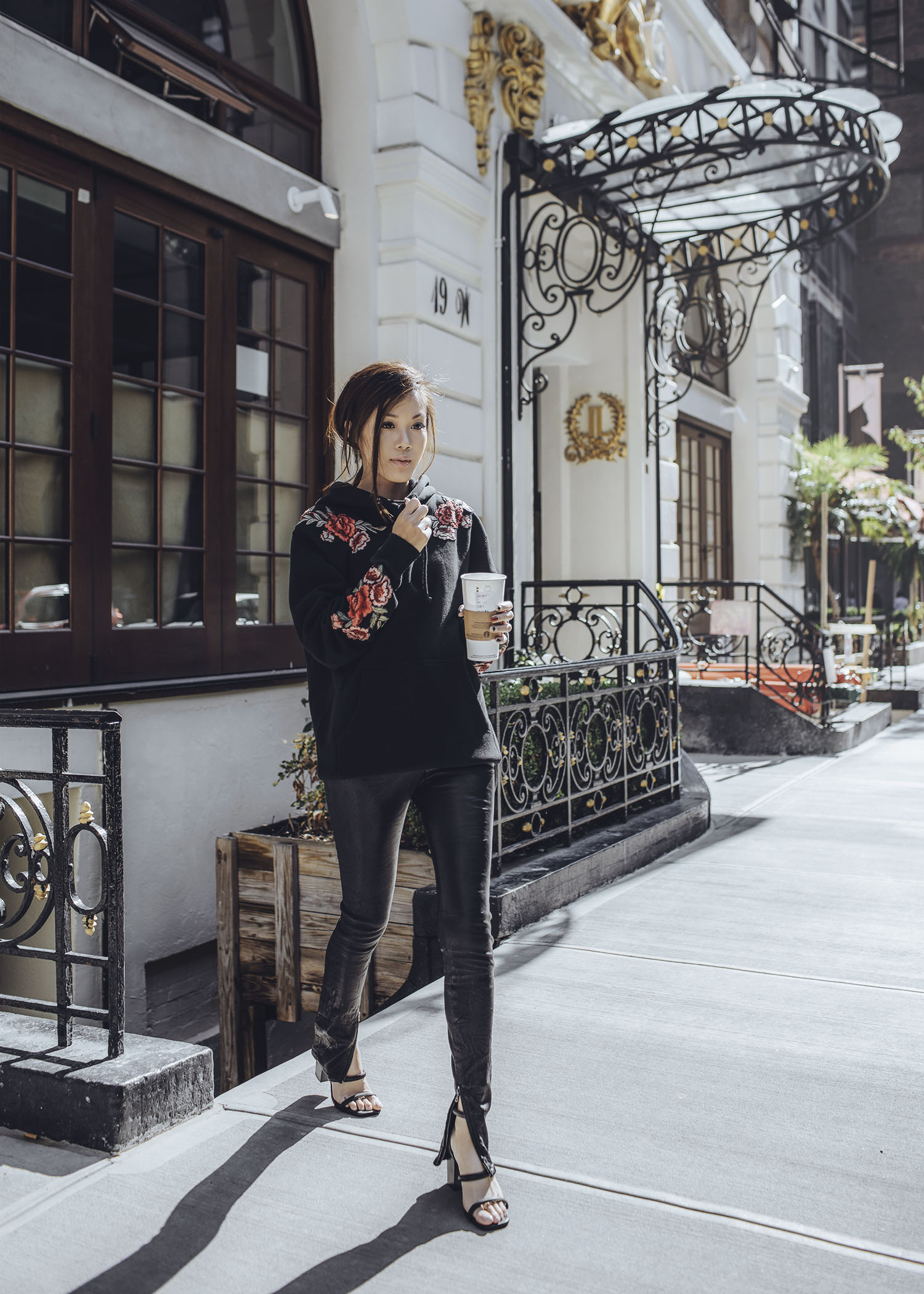 Jenny Tsang of Tsangtastic wearing floral patch sweatshirt ankle zip leather pant velvet military jacket red ruffle sweater and blue leather newsboy cap