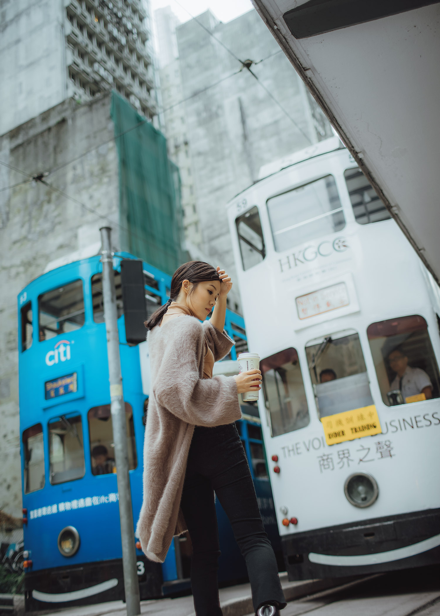 Jenny Tsang of Tsangtastic wearing bytsang fuzzy cardigan coat in Hong Kong Central riding the tram