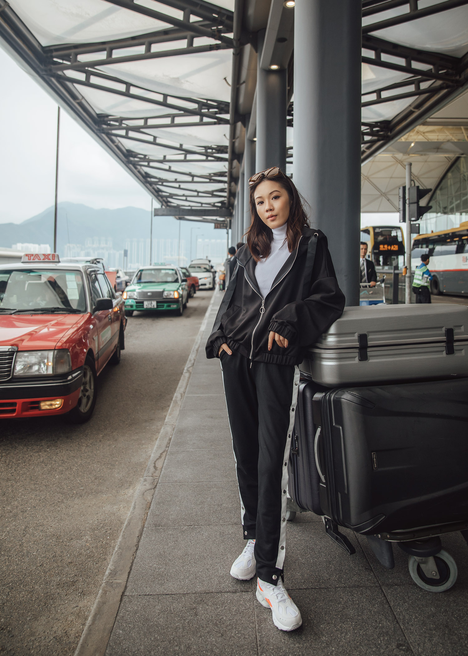 Jenny Tsang of Tsangtastic wearing airport activewear outfit in Hong Kong