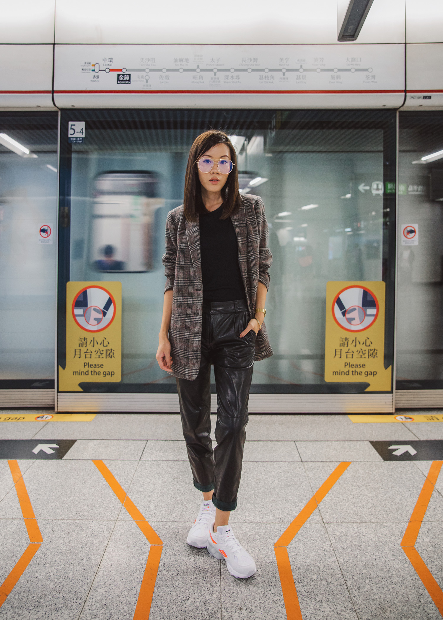 Jenny Tsang of Tsangtastic wearing plaid blazer leather pants daddy sneakers outfit in Hong Kong