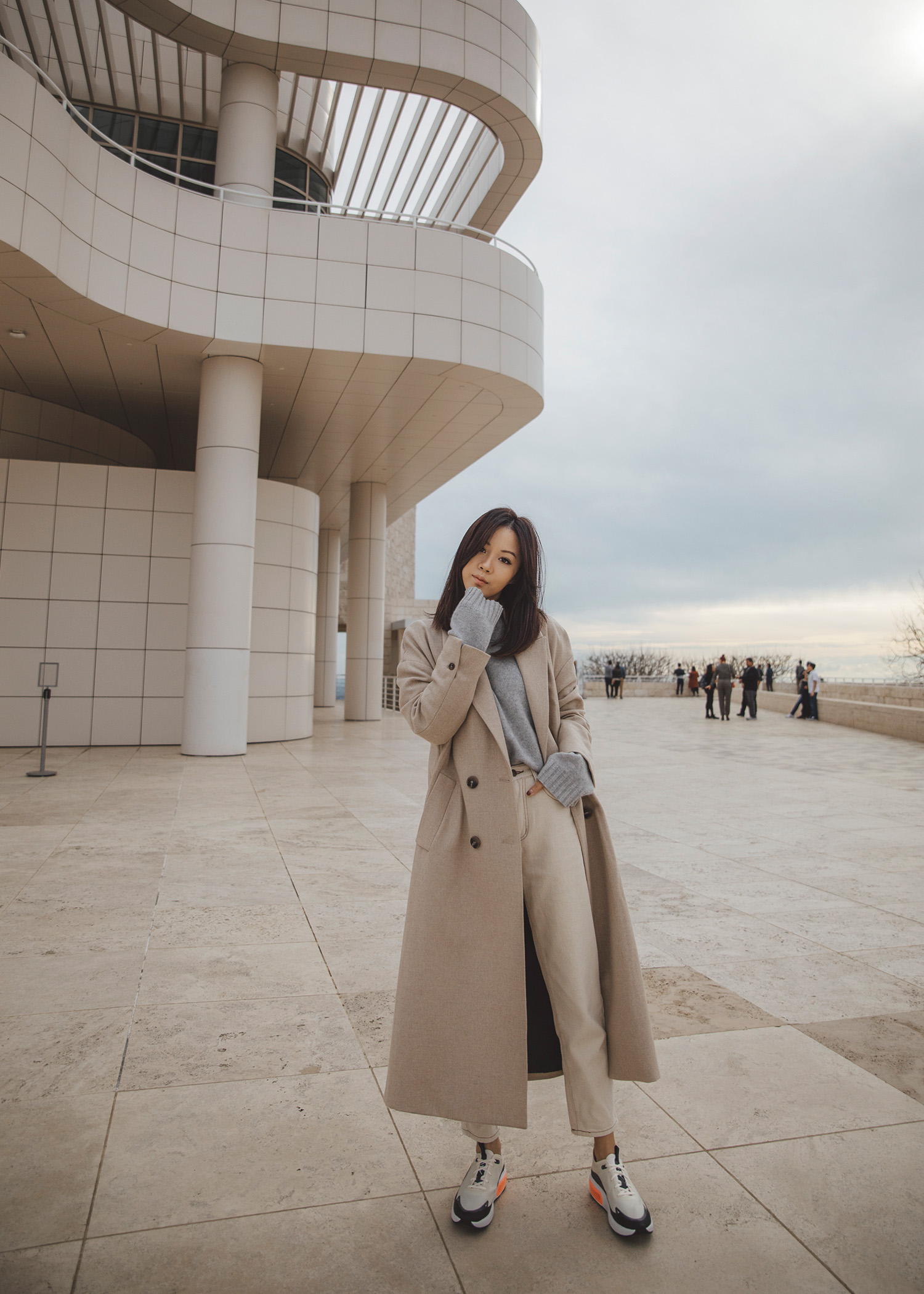 Jenny Tsang of Tsangtastic wearing long coat and nike air max dia monochromatic sneaker outfit